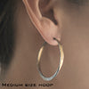 Off round Splash Hoop earrings with Barrel Closure in Sterling Silver and hammered 14K yellow gold shown on model by Ayesha Mayadas