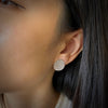 Leaf shaped earrings with diamonds in platinum shown on model by Ayesha Mayadas