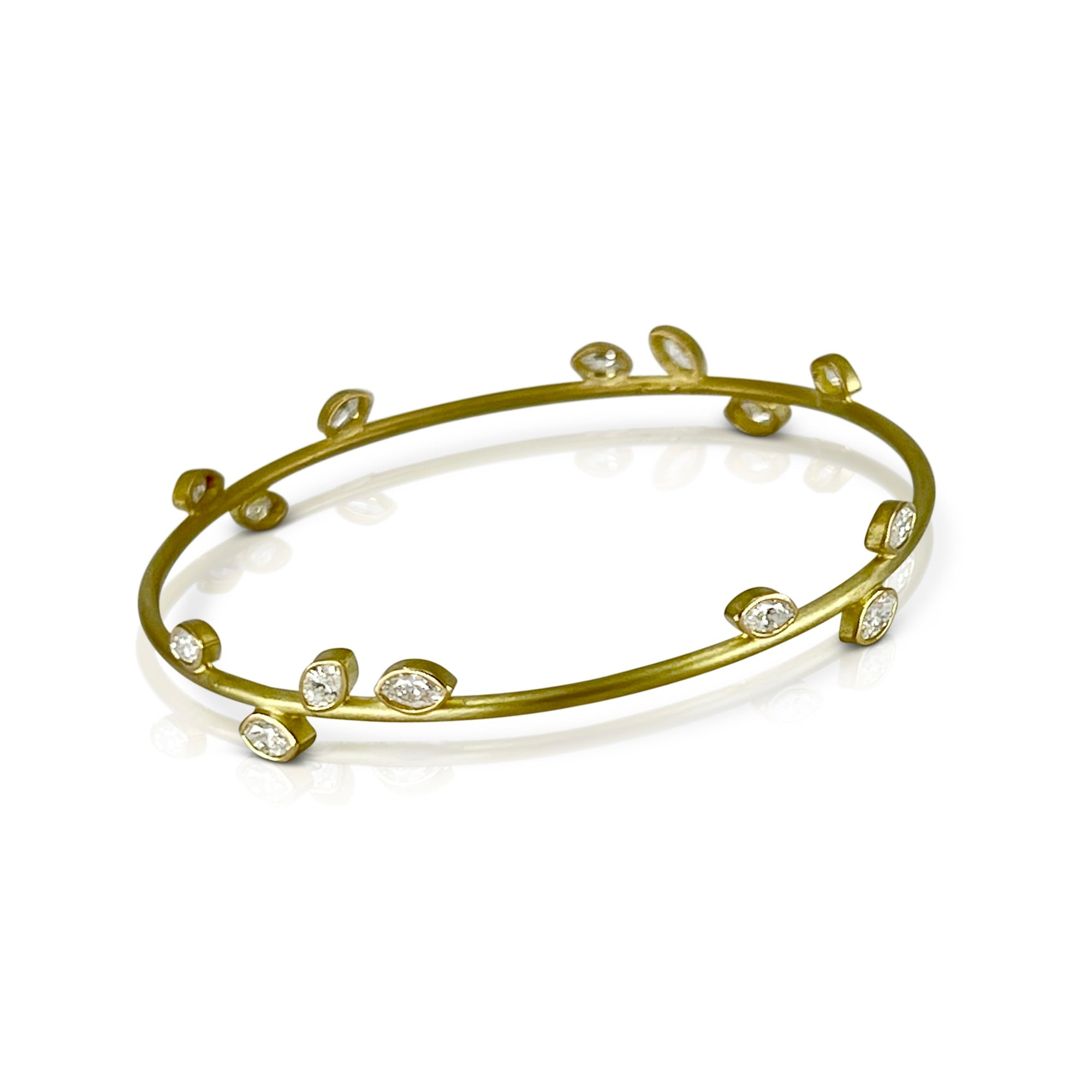 bangle bracelet in 18K Gold with 14 leaf shaped marquis diamonds shown on model made by Ayesha Mayadas