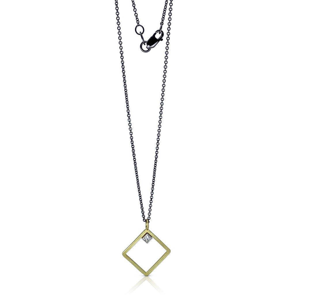 Diamond shaped, open frame pendant in 18K gold with a princess cut diamond on silver chain by Ayesha Mayadas