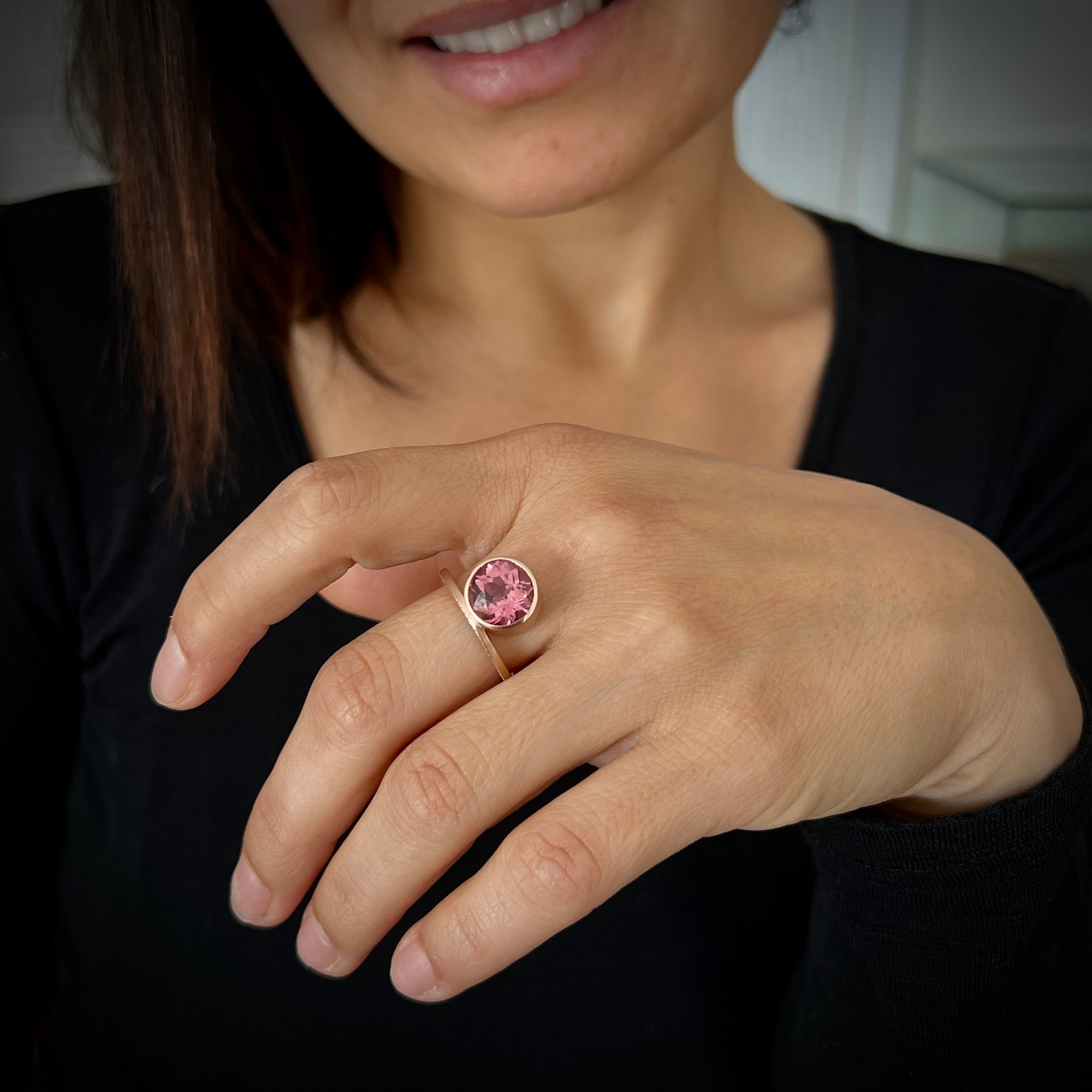 Cocktail ring in 18K pink gold with faceted pink tourmaline and pave set diamonds made by Ayesha Mayadas shown on model