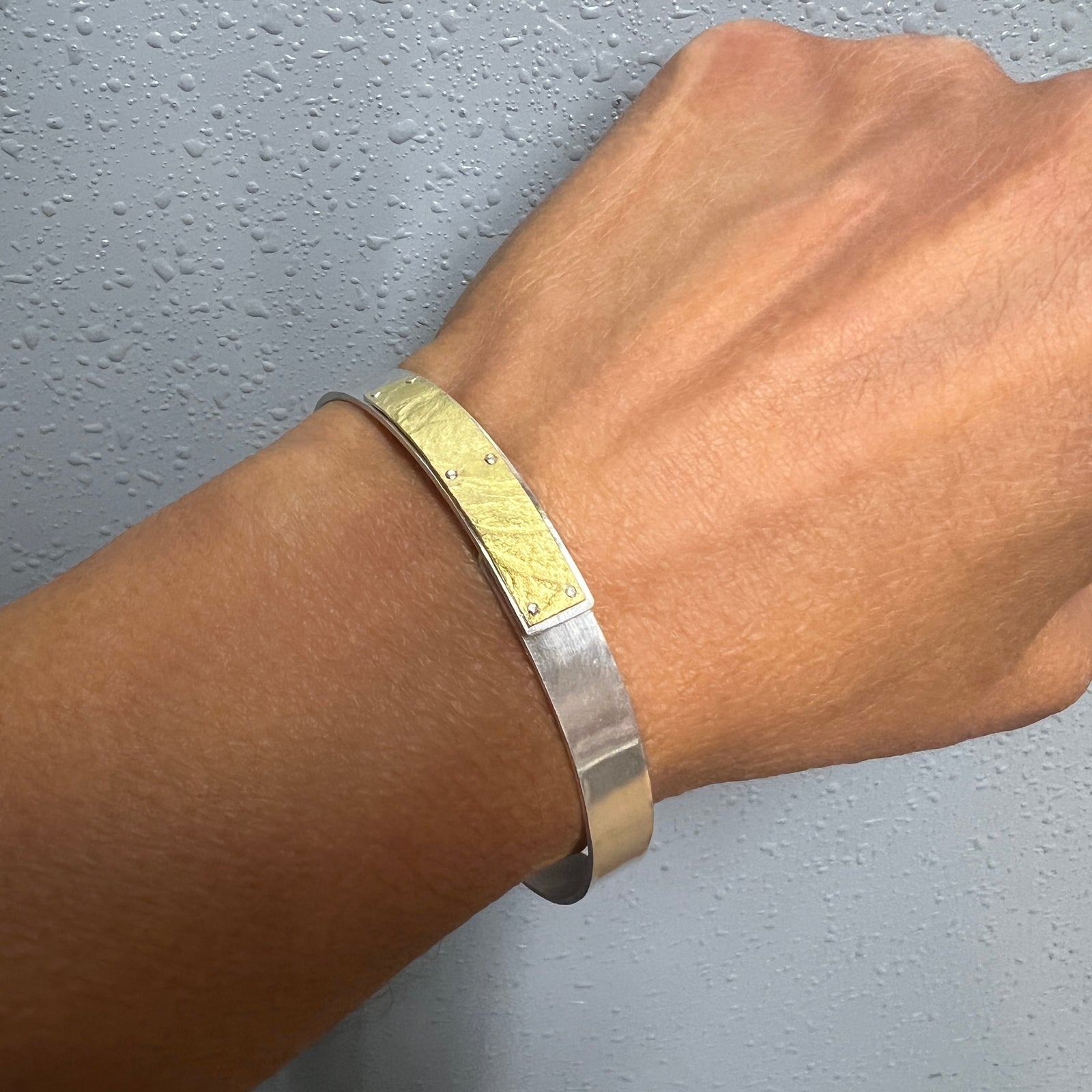 Narrow forged cuff in sterling silver with 18K gold textured tab