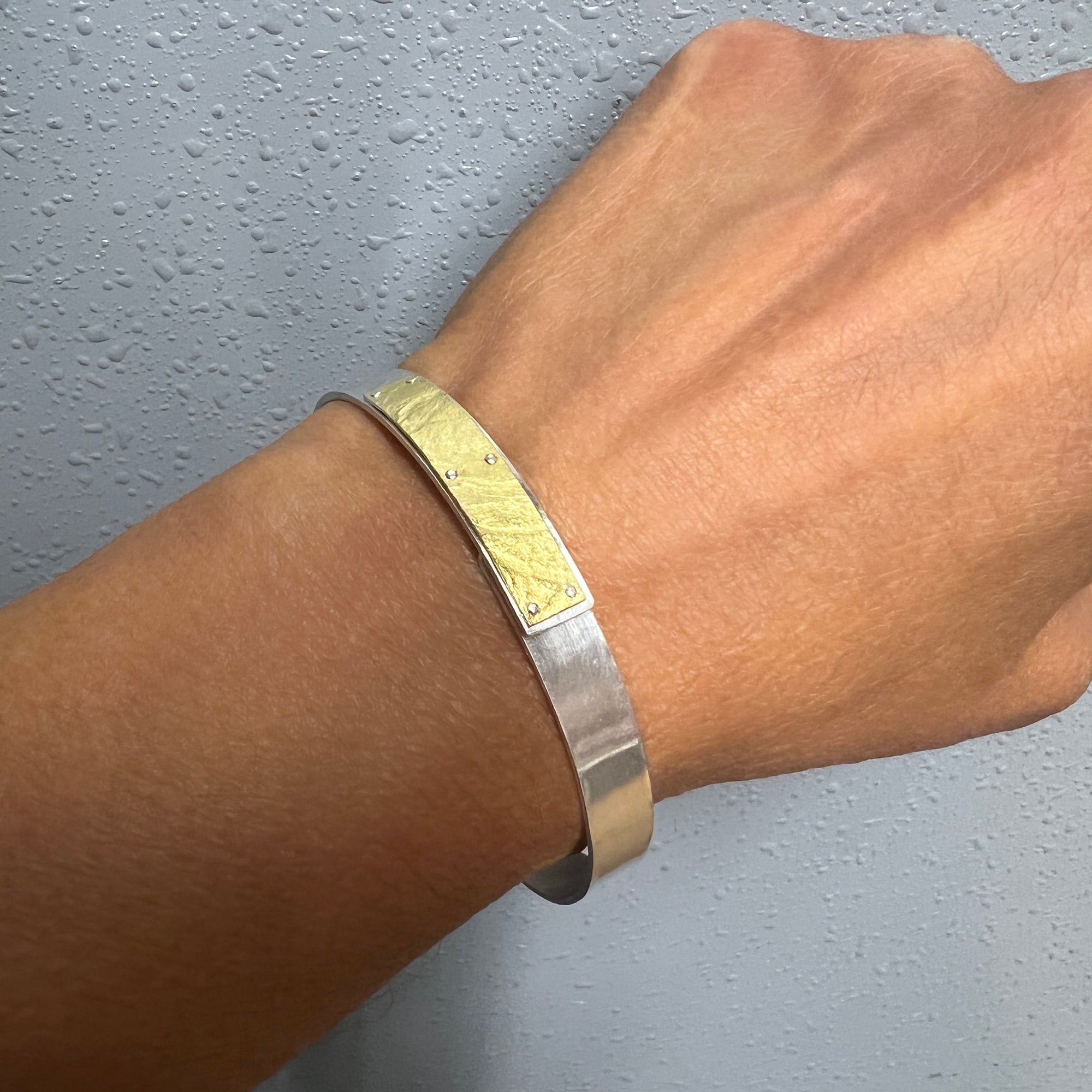 Narrow forged cuff in sterling silver with 18K gold textured tab