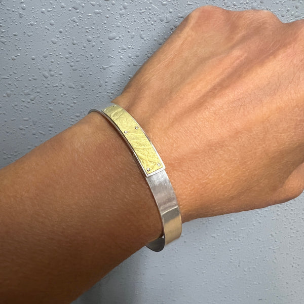 Narrow forged cuff in sterling silver with 18K gold textured tab ...