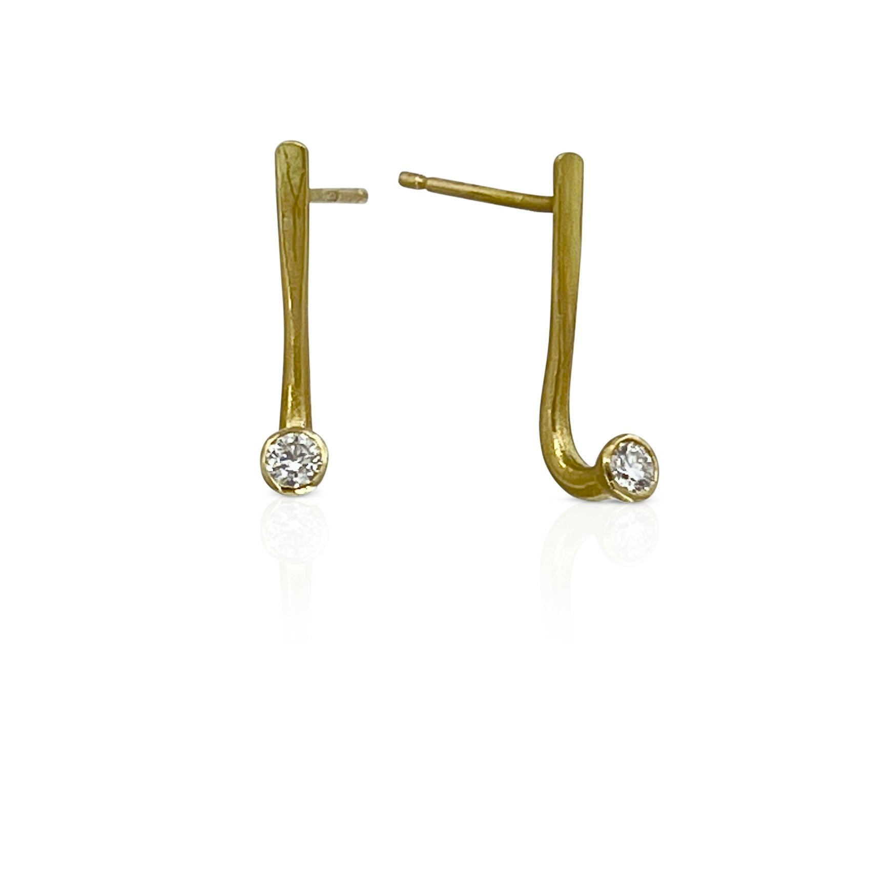 Earrings in 18K gold with stacked diamond drops with natural and lab grown diamonds shown on model made by Ayesha Mayadas