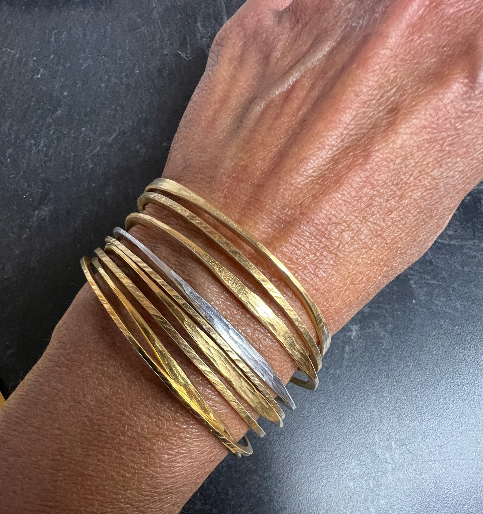 Splash off round Bangle in sterling silver with 18K yellow gold Vermeil finish by Ayesha Mayadas