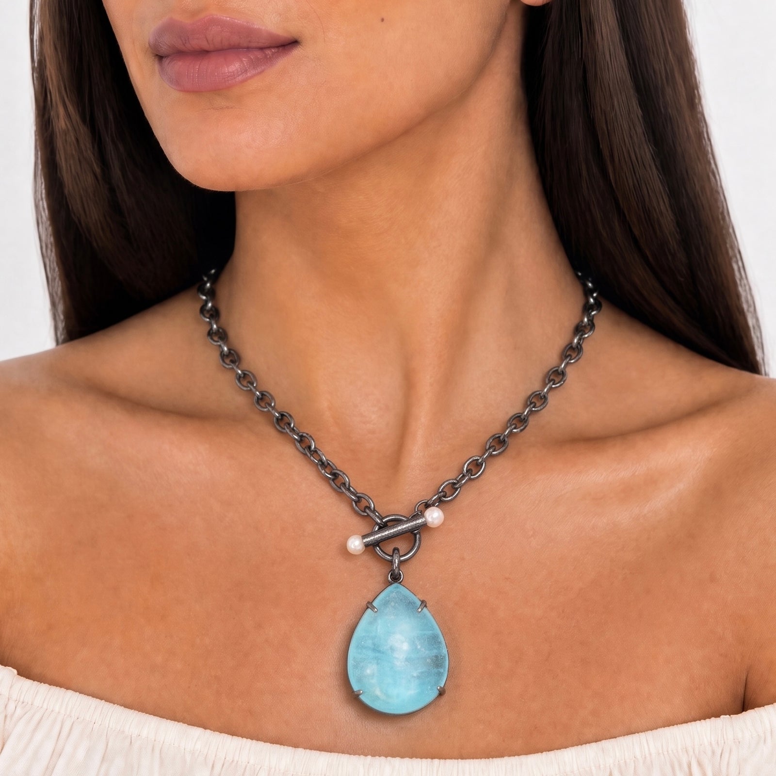 A luminescent aquamarine on a cable chain with a pearl accented toggle