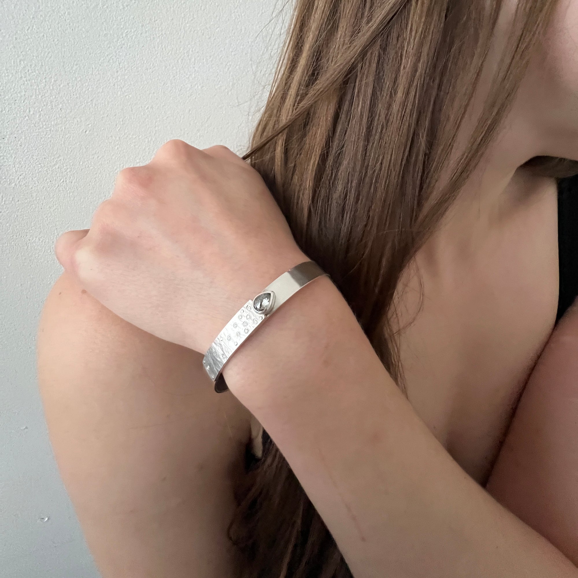 Narrow forged cuff (#2) in sterling silver with top closure and natural raw diamond