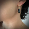 Gold huggie (hoops) with black facetted Spinel drop