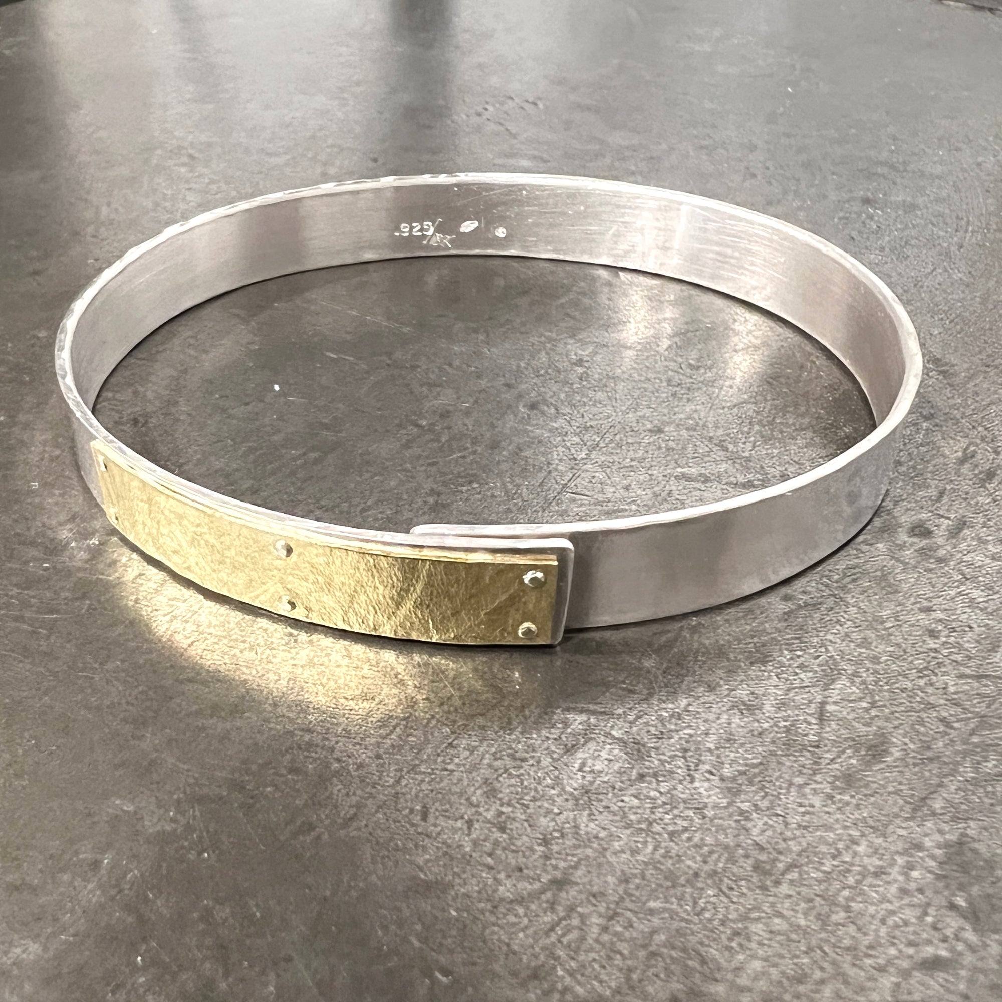 Narrow forged cuff in sterling silver with 18K gold textured tab