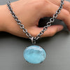 Large luminescent aquamarine pendant on a cable chain