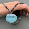 Large luminescent aquamarine pendant on a cable chain