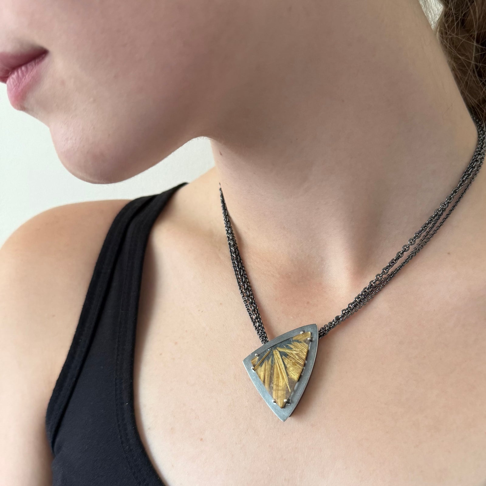 Necklace with striking rutliles in black and gold on multi strand chain