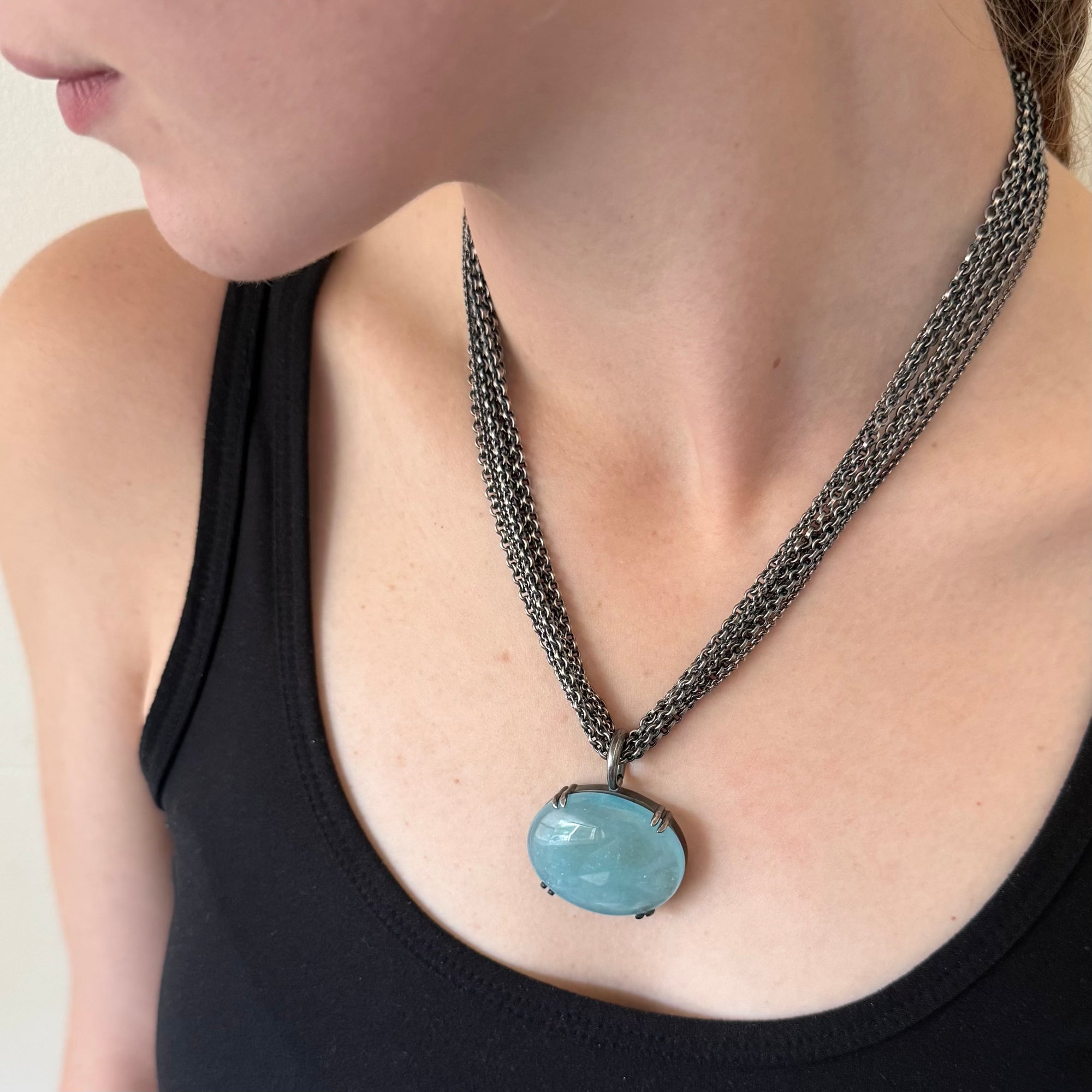 Large luminescent aquamarine pendant on a multistrand chain