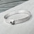 Narrow forged cuff (#2) in sterling silver with top closure and natural raw diamond