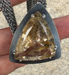 Necklace with faceted rutilated quartz with striking rutiles and a multi strand chain
