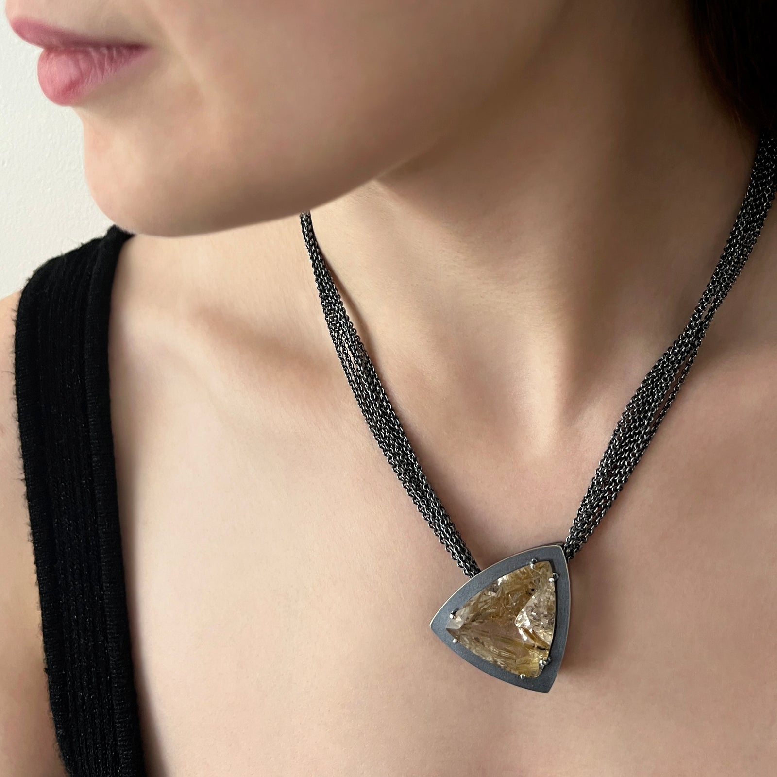 Necklace with faceted rutilated quartz with striking rutiles and a multi strand chain