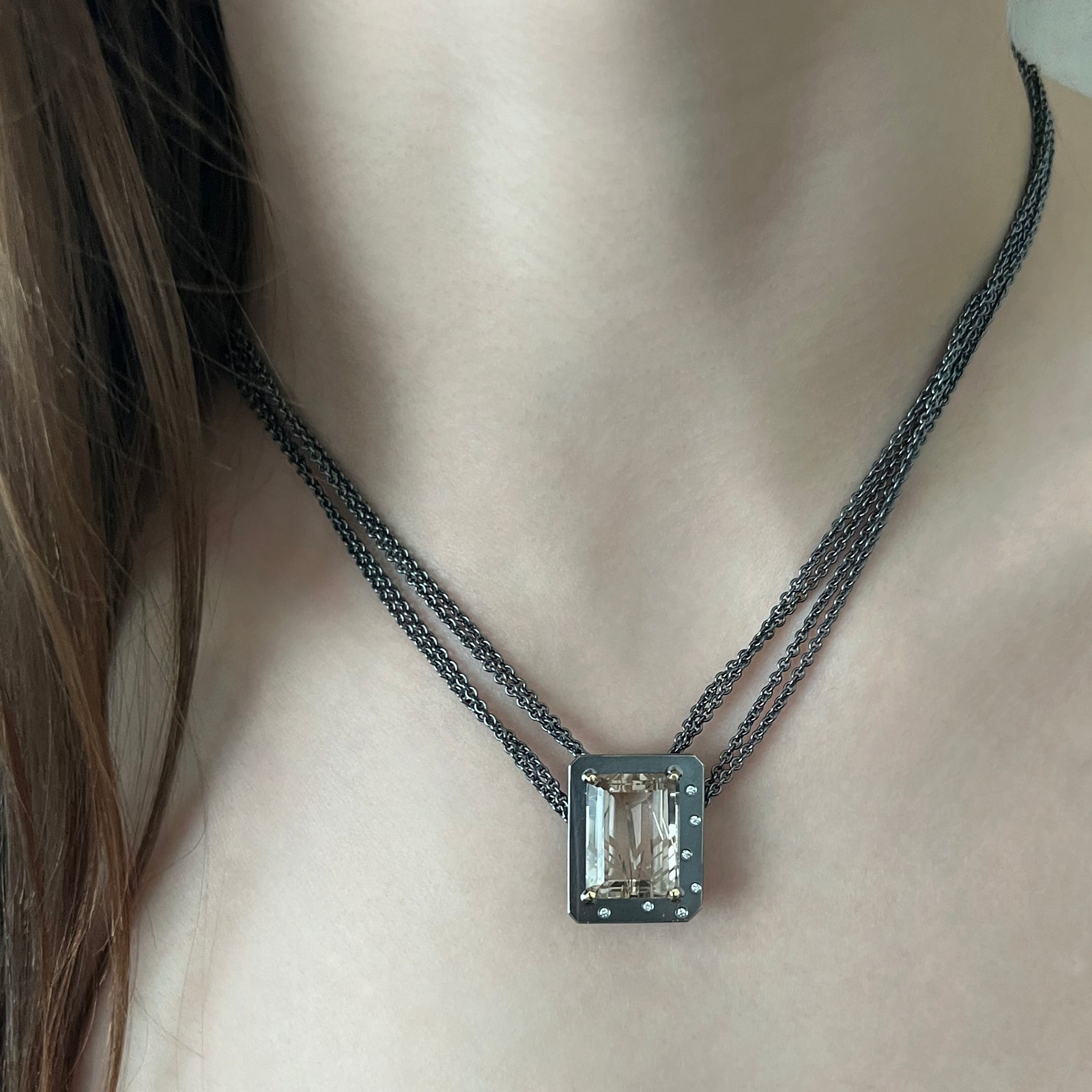 Emerald-cut rutilated quartz necklace with diamonds on a multi-strand chain