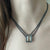 Emerald-cut rutilated quartz necklace with diamonds on a multi-strand chain