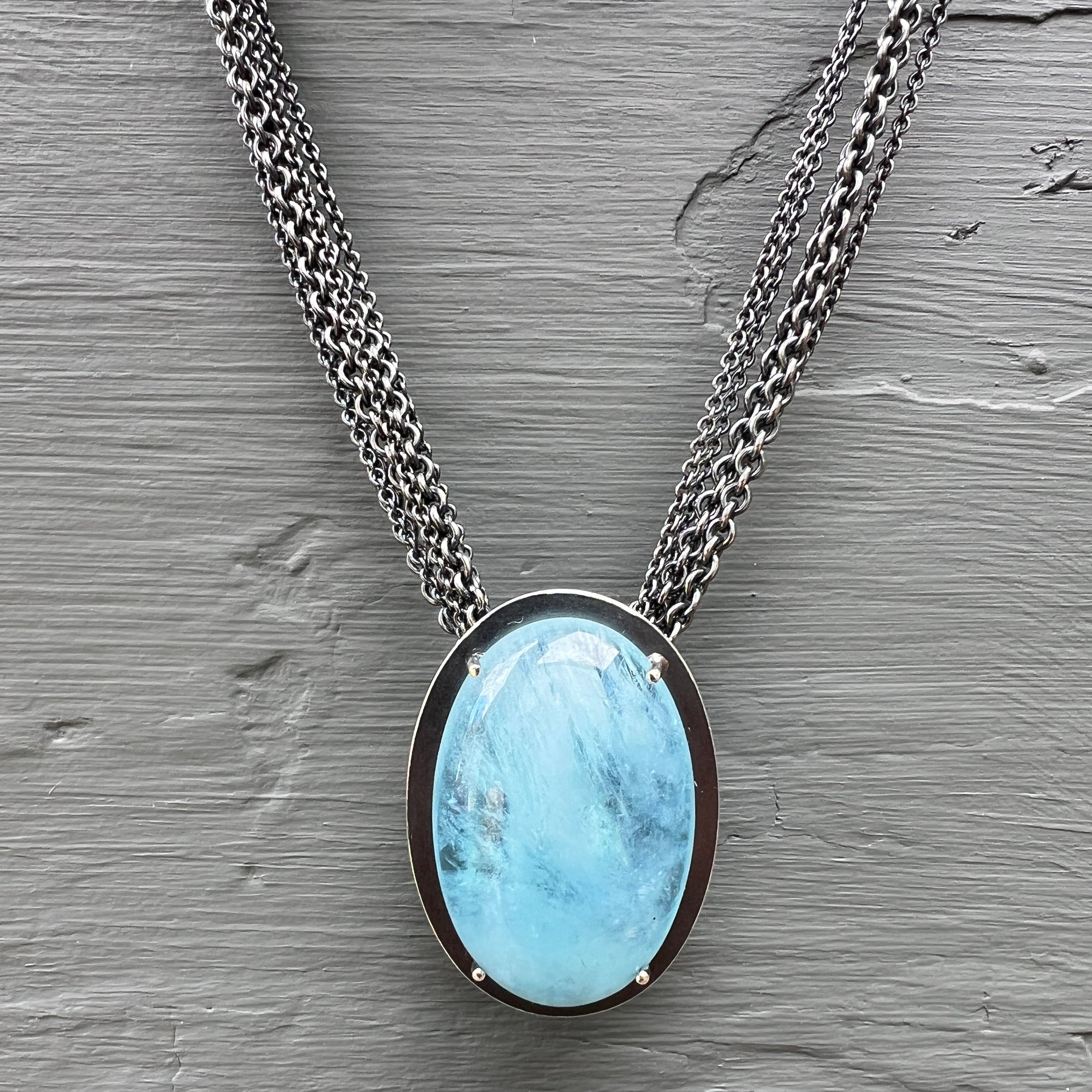 Necklace with a luscious aquamarine cabochon on a multi-strand chain