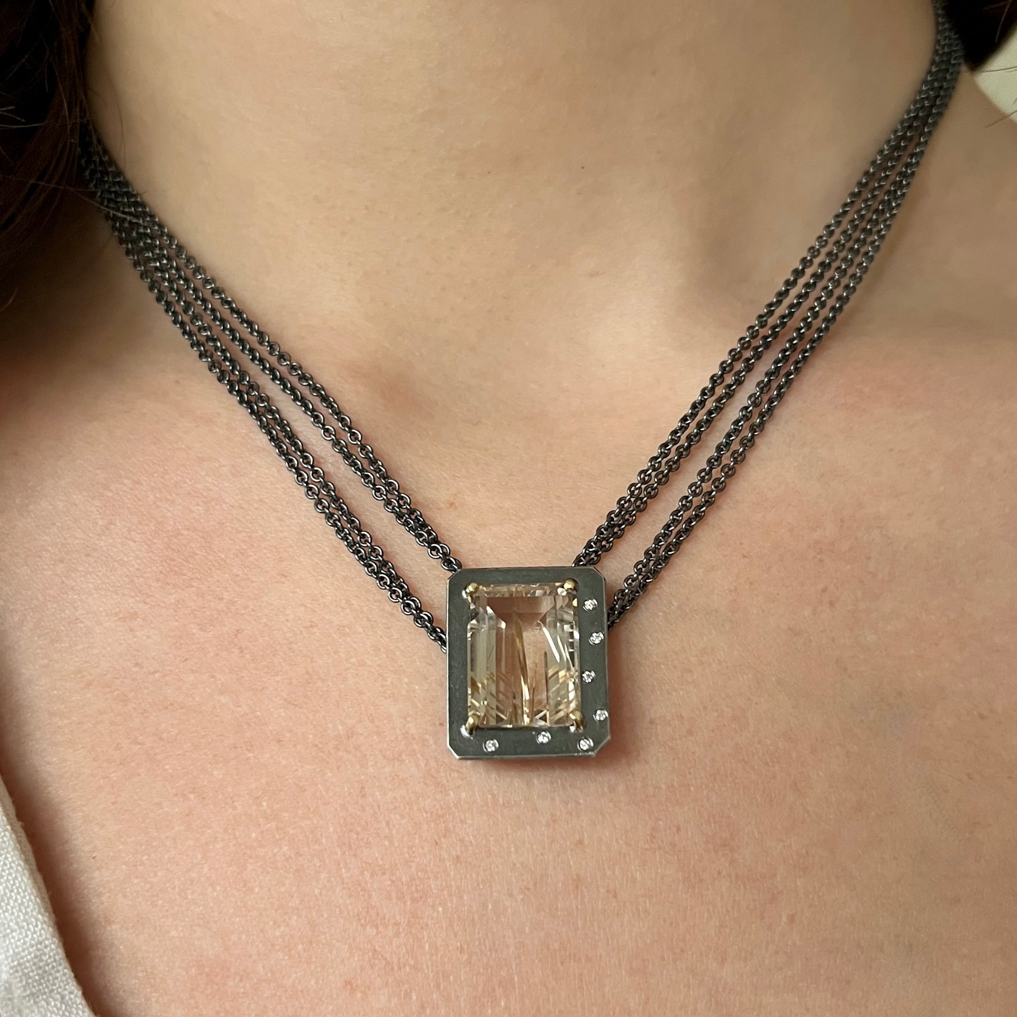 Emerald-cut rutilated quartz necklace with diamonds on a multi-strand chain