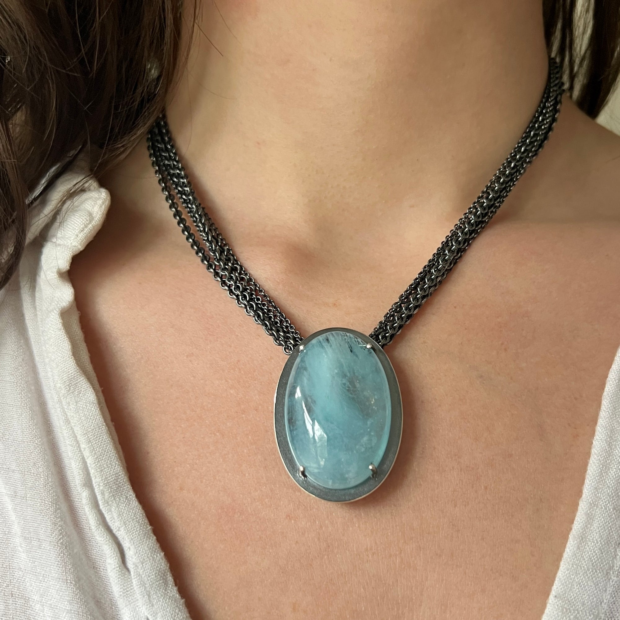 Necklace with a luscious aquamarine cabochon on a multi-strand chain