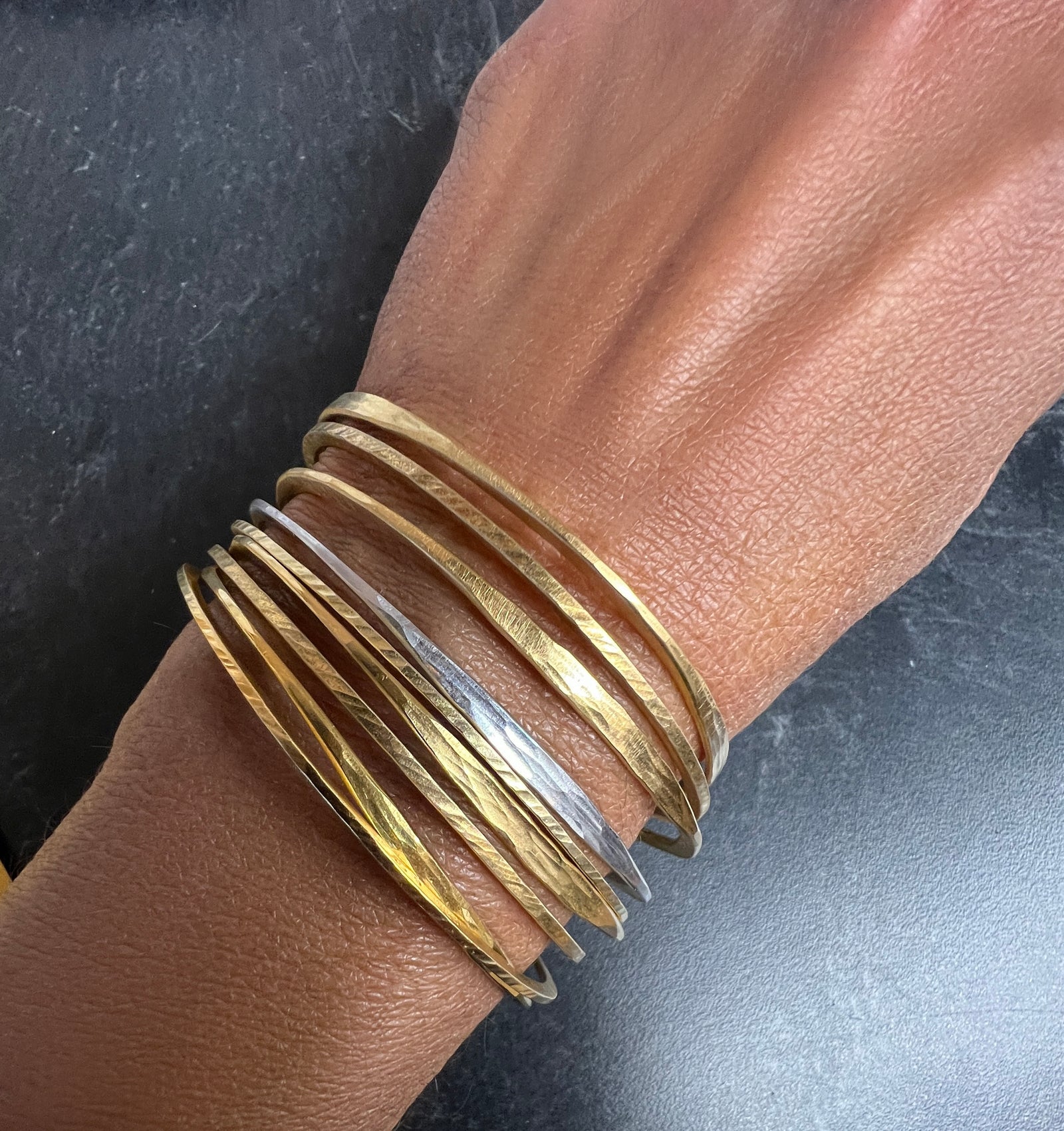 Splash off round Bangle in sterling silver with 18K yellow gold Vermeil finish by Ayesha Mayadas