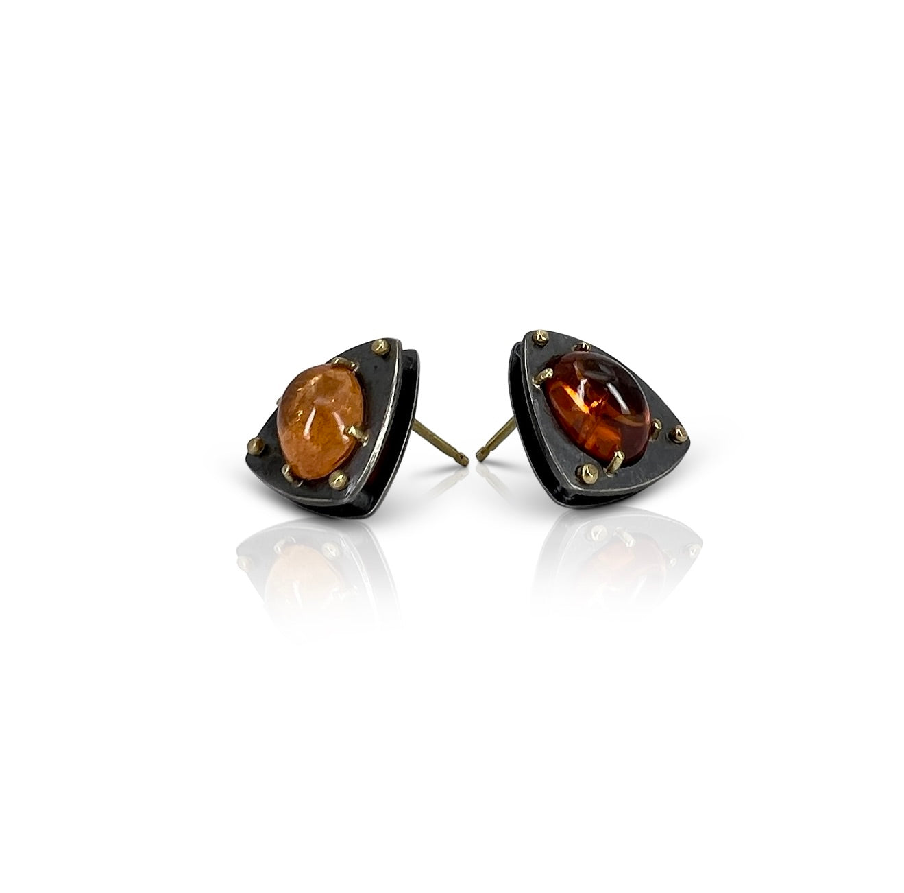 Geometric Sterling Silver earrings with 18kt gold rivets and oval Spessarsite garnet by Ayesha Mayadas