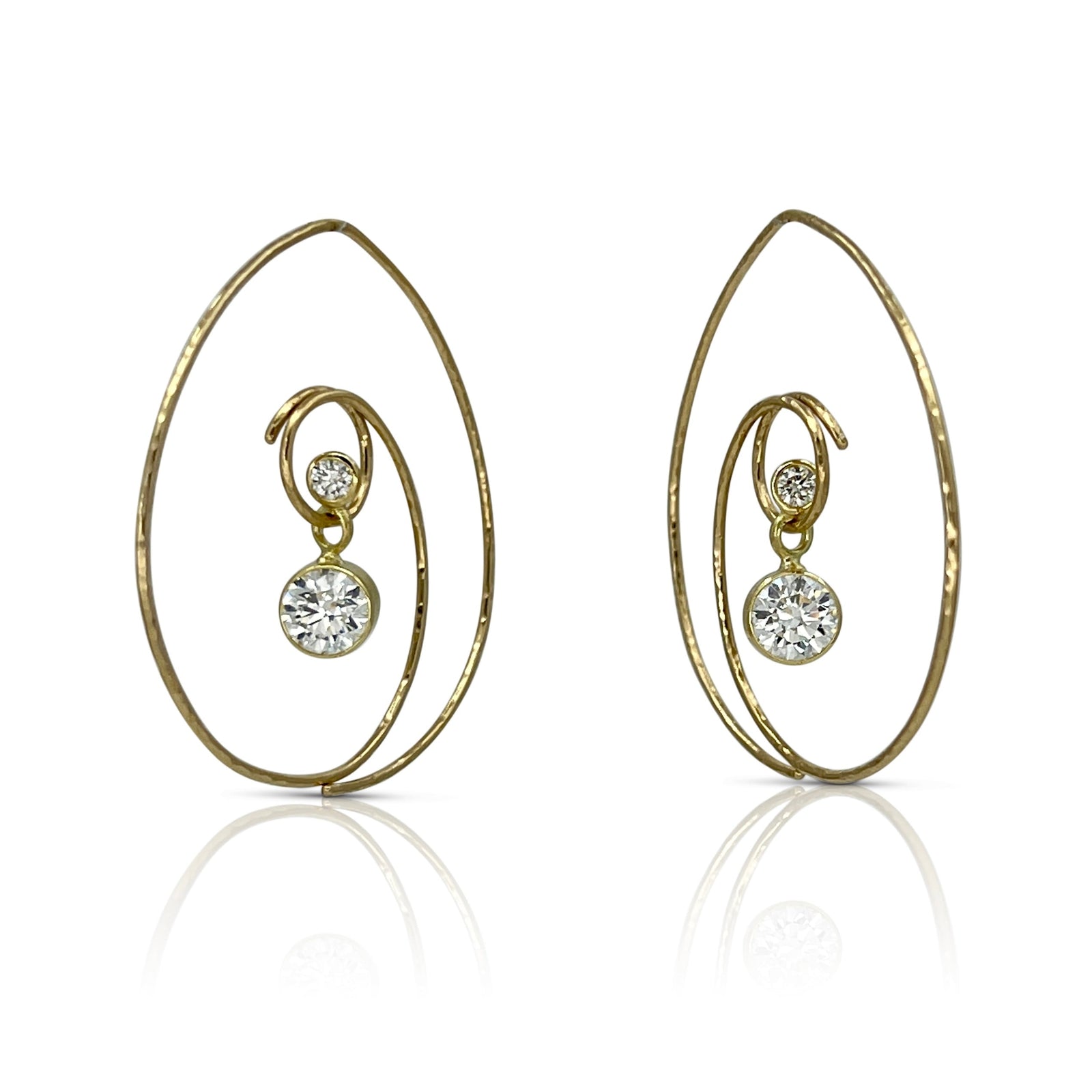 hoop earrings in 18K yellow gold with a duo of dangling natural diamonds and moissanite shown on model made by Ayesha Mayadas