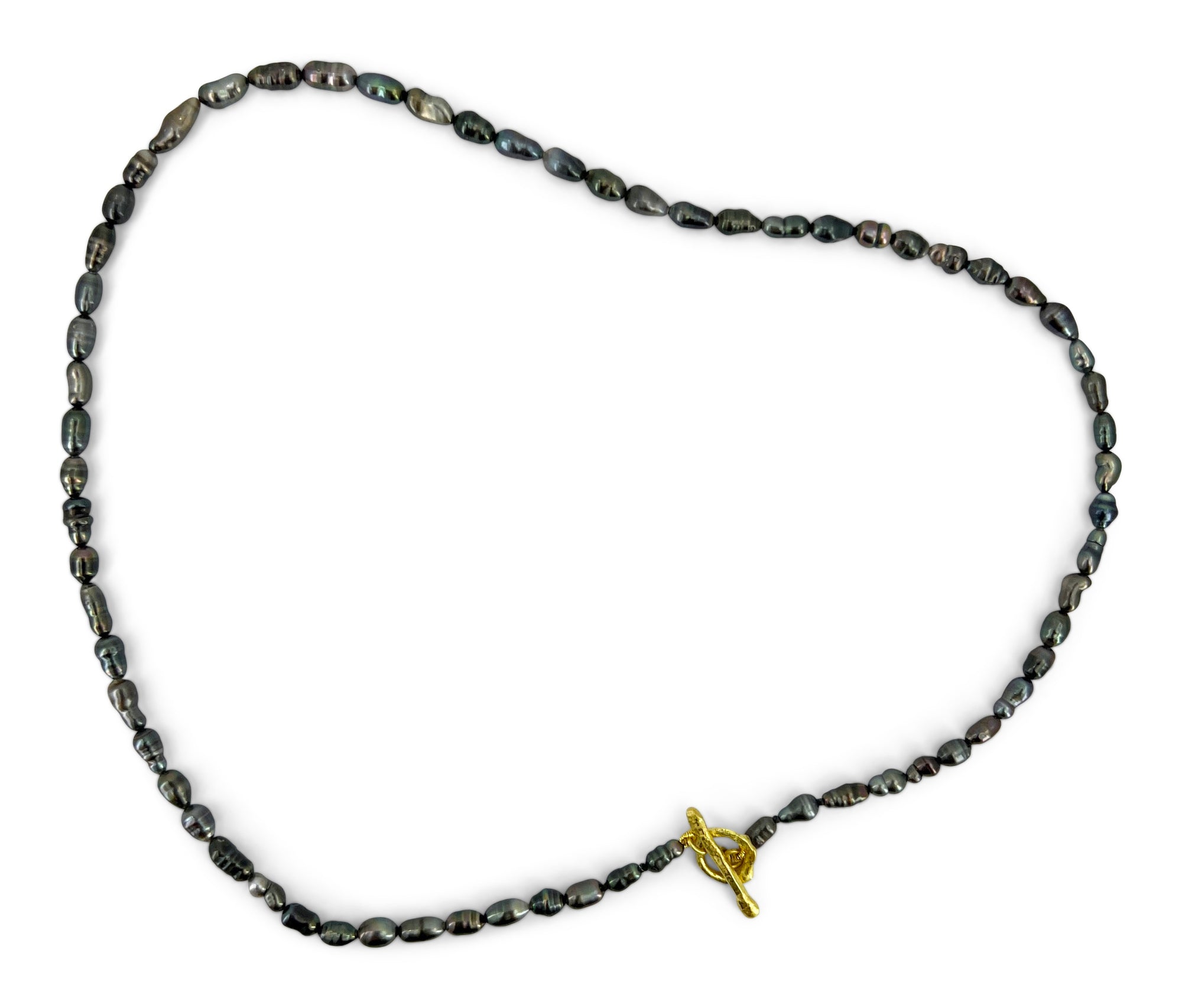 Tiny black Tahitian pearl strand with a free form 18K yellow gold toggle clasp