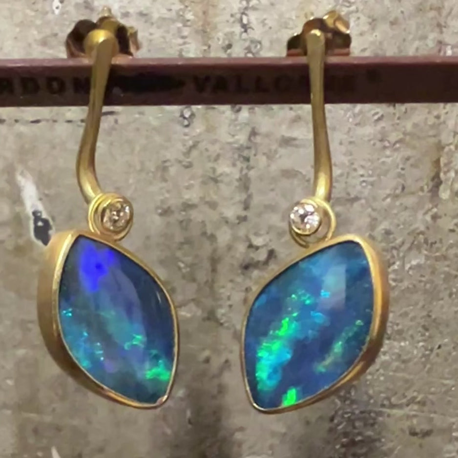 Driftwood earrings with opals suspended at an angle