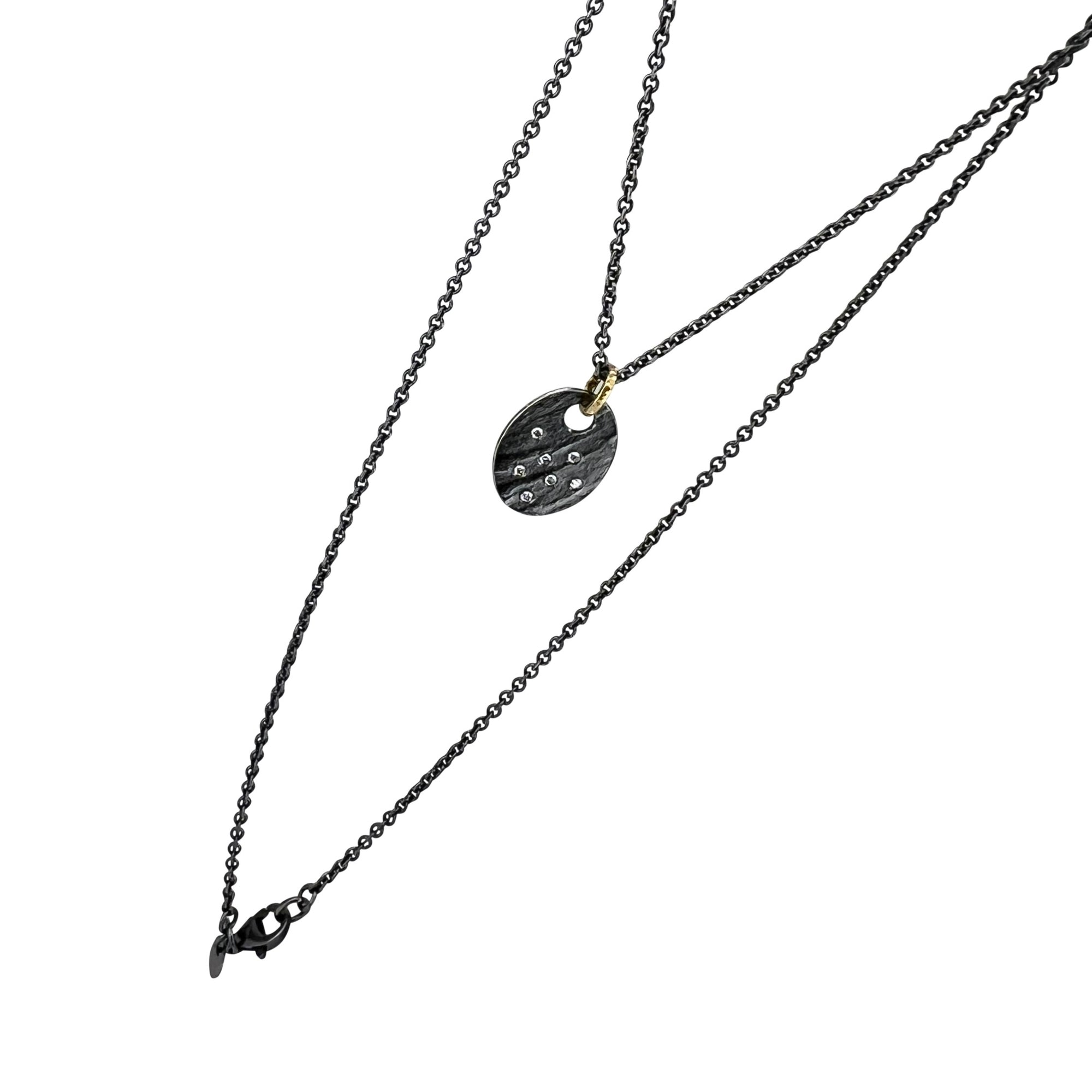 Oval disc pendant in Sterling Silver with diamonds