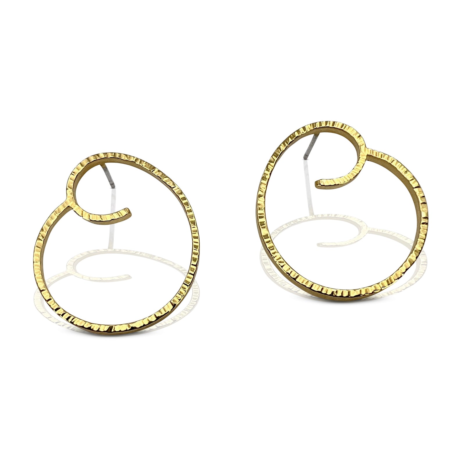 Simple spiral earrings in forged sterling silver with gold Vermeil finish shown on model made by Ayesha Mayadas