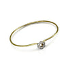 Gold bracelet with a floral clasp on a white background