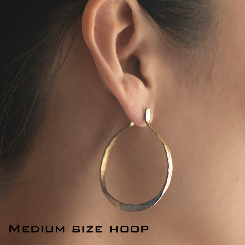 large size Splash Hoop off round Earrings in  14K yellow hammered Gold overlay on Silver shown on model by Ayesha Mayadas
