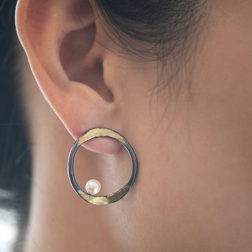 V forged hoop earrings with a splash of 14K yellow gold on oxidized sterling silver with fresh water pearl by Ayesha Mayadas
