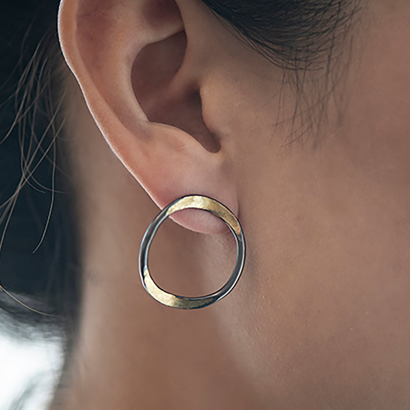 V forged hoops with a splash of 14K gold on oxidized sterling silver by Ayesha Mayadas
