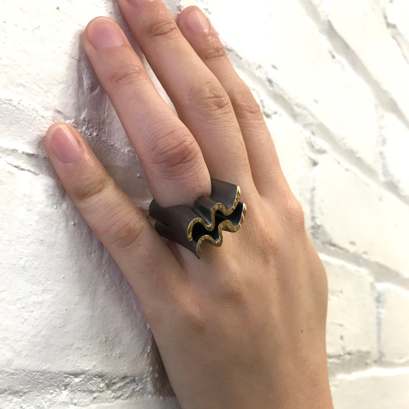 Tall wave ring in sterling silver with 14K yellow gold overlay shown on model by Ayesha Mayadas