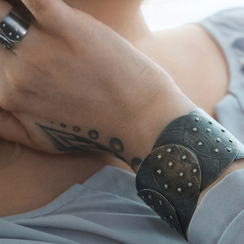 Wide sterling silver cuff with overlapping disks with diamonds by Ayesha Mayadas