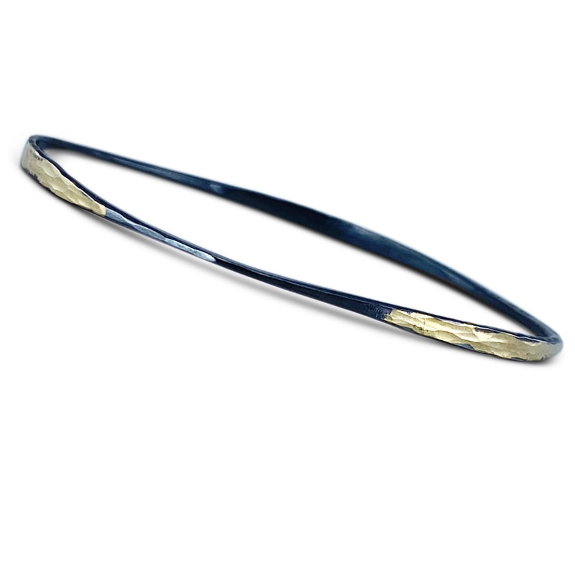 Oxidized sterling silver off-round bangle bracelet with 14K yellow gold overlay by Ayesha Mayadas