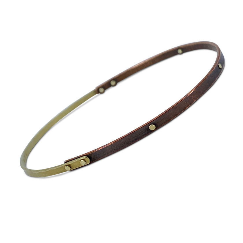 Rivet bangle bracelet in 18K yellow gold and copper slightly oval shaped by Ayesha Mayadas
