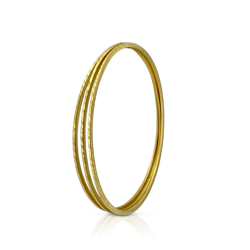 Skinny bangle in sterling silver with 18K yellow gold Vermeil finish by Ayesha Mayadas