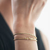 Model is wearing linear cuff and Stepped cuff with diamonds in 18K yellow gold by Ayesha Mayadas 