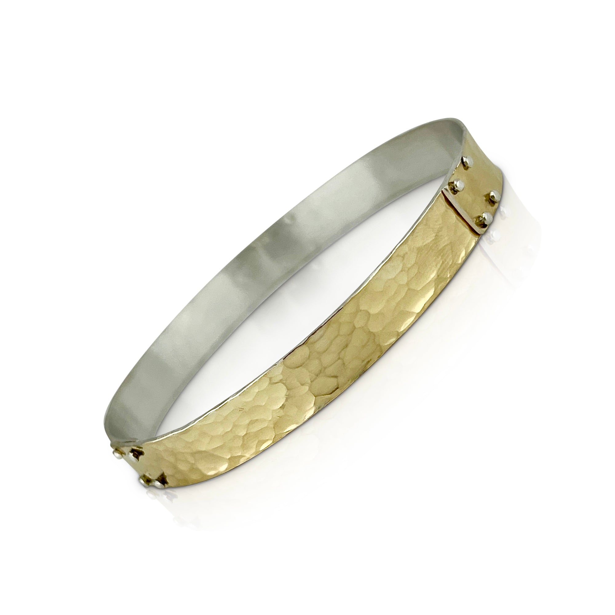 Hand forged with three sections of rivets spaced evenly around the bangle.  Wear it by itself or stack with others.  18K yellow gold and sterling silver bi-metal bangle by Ayesha Mayadas