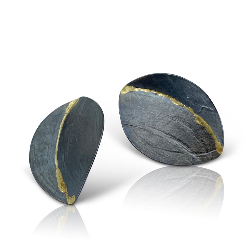 Leaf motif earrings in oxidized sterling silver and a stripe of 14K yellow gold by Ayesha Mayadas