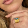Wide Wafer texture ring in 18K yellow gold with marquis shaped cabochon aquamarine shown on model by Ayesha Mayadas