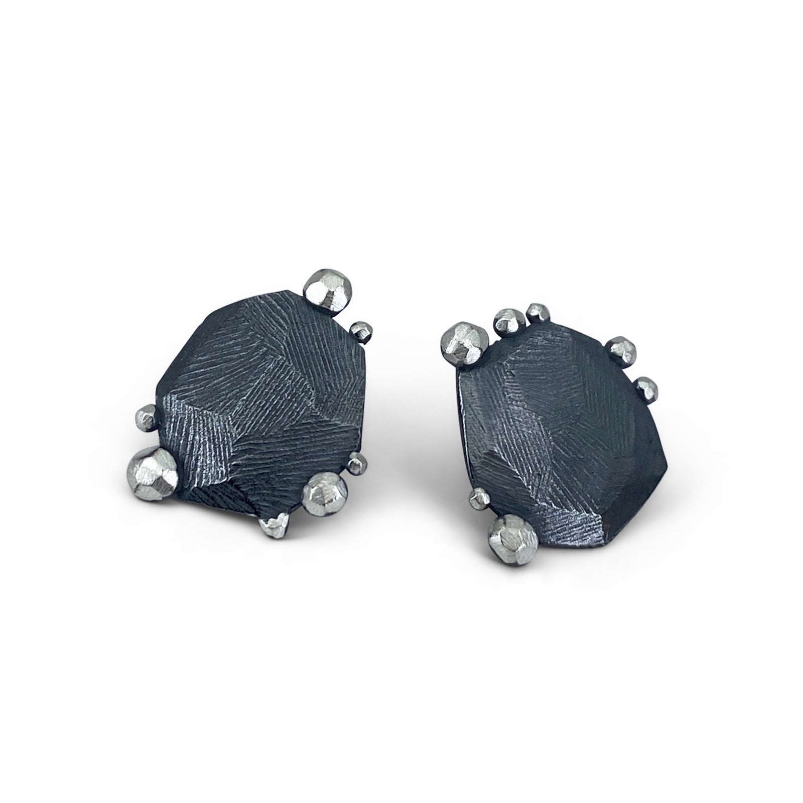 Facet Edge Stud earrings in sterling silver shown on model made by Dahlia Kanner