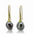 Slender, long, 18K yellow gold earrings with black Tahitian pearls on sculpted gold wires by Ayesha Mayadas