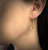 Vortex oval Hoop Earrings in 18K yellow gold or platinum and lab diamonds shown on model made by Ayesha Mayadas