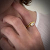 Serpentine ring with 0.33 ct marquis diamond in 18K yellow gold by Ayesha Mayadas shown on model